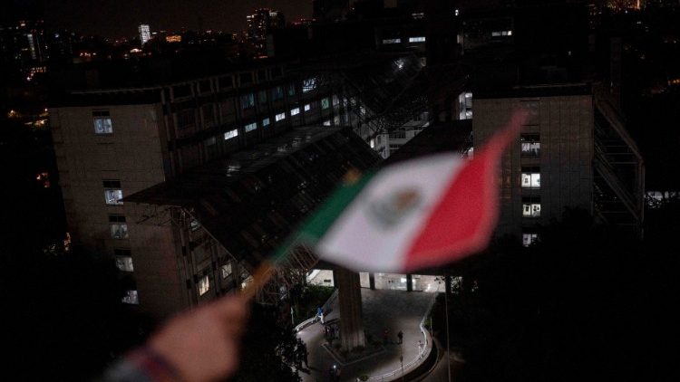 A man waves a Mexican flag from his window amid the coronavirus pandemic