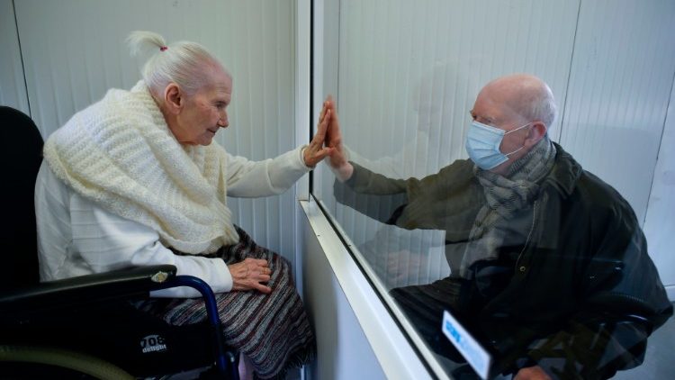 An elderly woman infected with Covid-19 meeting her son at an old age home in Belgium.