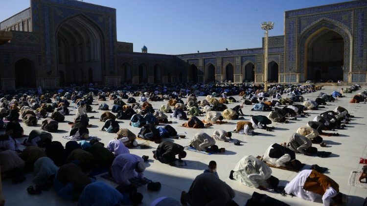 Muslims pray at the start of the Eid al-Fitr festival in Herat