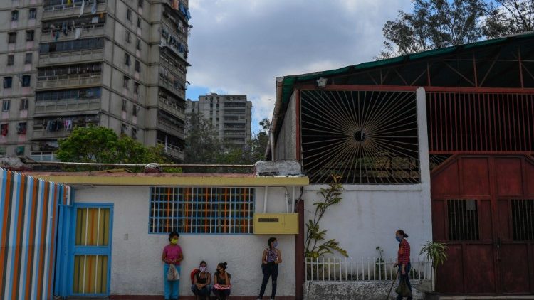 Des personnes attendent pour une distribution de nourriture par des religieuses à Caracas, dans le quartier de Casalta, le 22 mai 2020