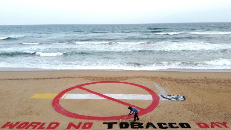 Indian sand artist Sudarshan Patnaik with an artwork on the eve of World No Tobacco Day 2020. 