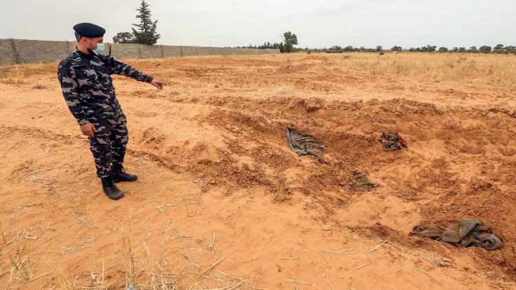 A Libyan soldier stands at the reported site of a mass grave in Tarhuna, Libya