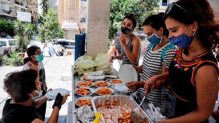 Volunteers distribute meals to people affected by the blast in Beirut