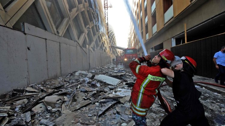 Lebanese firefighters douse the flames of a blaze that engulfed a Beirut building designed by Zaha Hadid