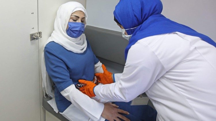 A Lebanese midwife examining a pregnant woman in Beirut, Lebanon. 