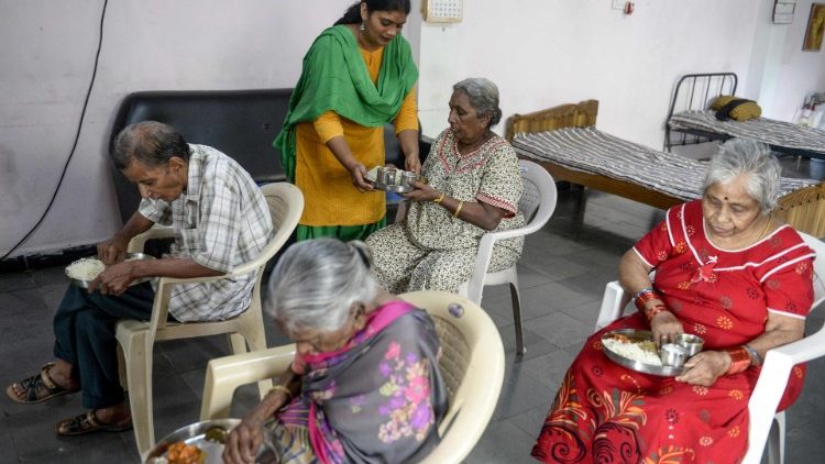 A caregiver tends to elderly people at a home for older people in Secunderabad, India. 