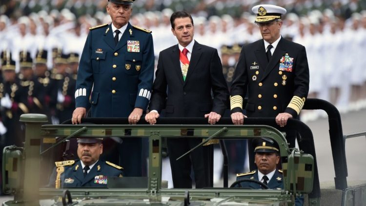 Archive photo of the Mexican President Pena Nieto (C) with Defense Secretary (L) General Salvador Cienfuegos during a parade
