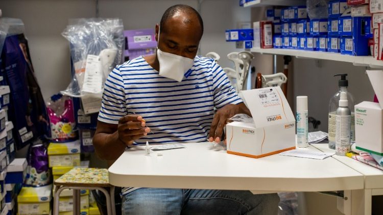 Un pharmacien, à Capesterre-Belle-Eau en Guadeloupe, observant un kit de détection du coronavirus. 