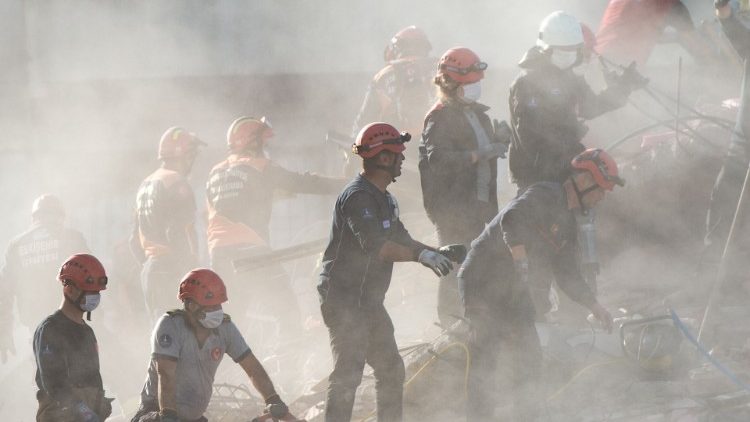 Search and rescue volunteers search the rubble of a collapsed building in Izmir