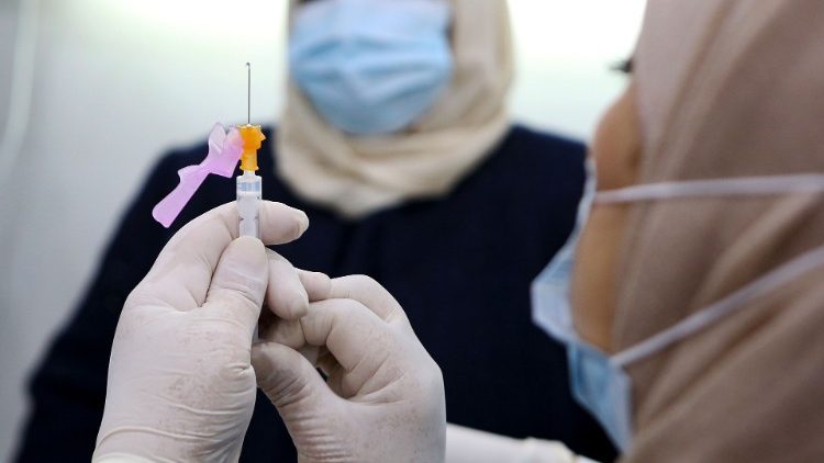 A nurse prepares to administer a Covid-19 vaccine in Kuwait