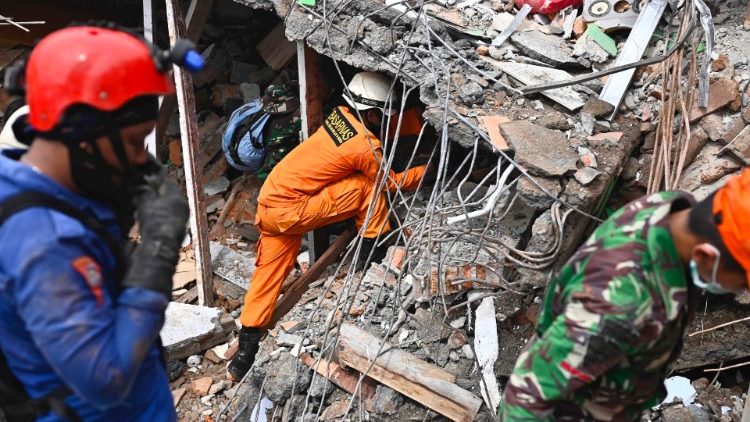 इंडोनेशिया में भुकम्प के बाद राहतकर्मी ध्वस्त घरों में दबे लोगों की खोज करते
