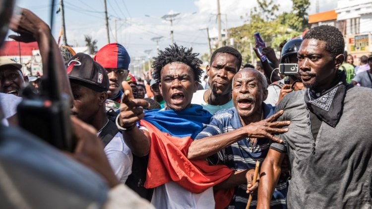 Demonstrators march in Port-au-Prince on 14 February 2021, to protest against the government of President Jovenel Moise.