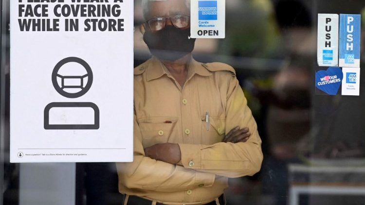 A security guard wears a mask inside a store in New Delhi, India
