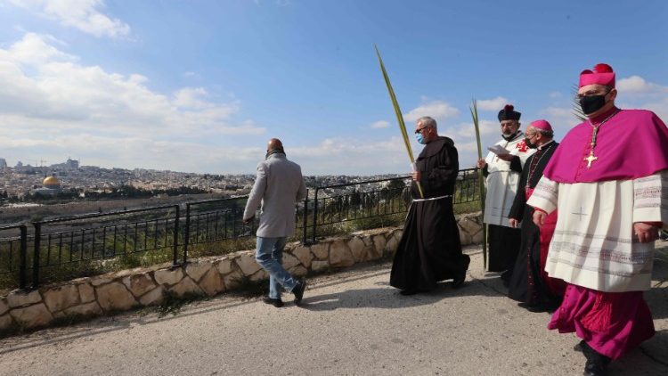 Latin Patriarch of Jerusalem, Pierbattista Pazzaballa, marches with clergymen and worshippers in a Palm Sunday procession on the Mount of Olives, 28 March