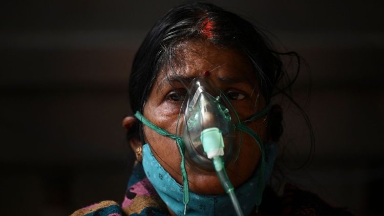Paciente Covid-19 respira com a ajuda de oxigênio fornecido por um Gurdwara, um local de culto Sikh, sob uma tenda instalada ao longo da estrada em meio à pandemia de coronavírus Covid-19 em Ghaziabad em 2 de maio de 2021. (Foto de Sajjad HUSSAIN / AFP)
