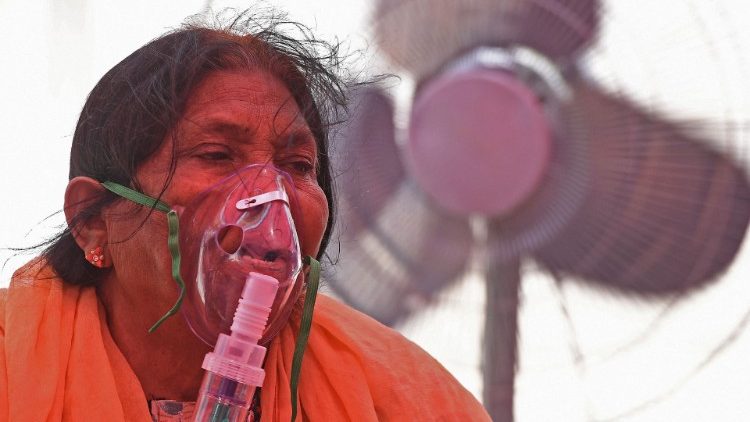 A woman breathes with the help of an oxygen mask in Ghaziabad