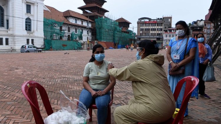  A health worker inoculates a woman with anti-Covid vaccine in Kathmandu, Nepal.