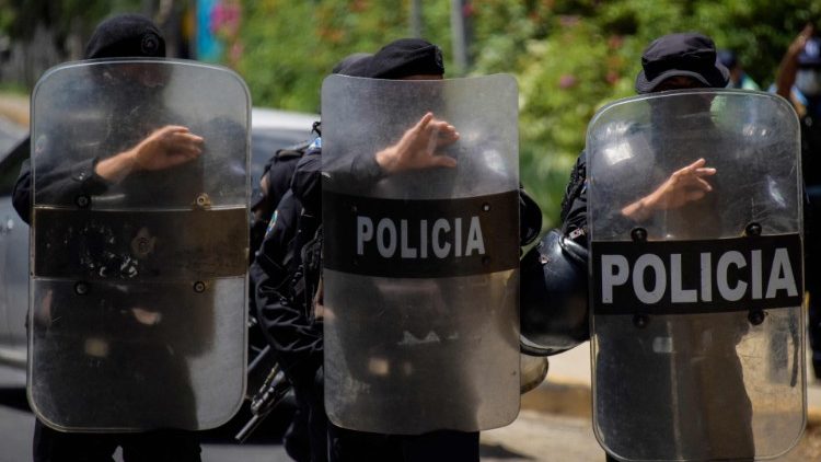 Riot police stand guard outside the house of Cristiana Chamorro