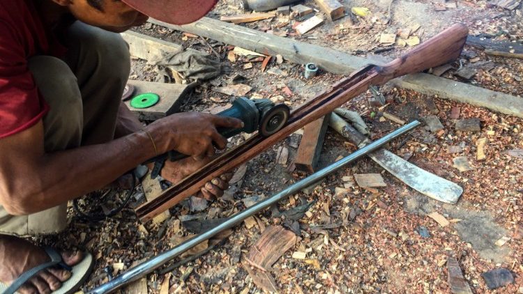 A member of the People's Defence Force in Myanmar makes a handmade gun to be used in fighting against security forces in Kayah state 