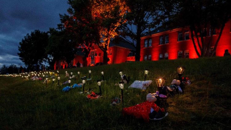 Shoes, flowers and stuffed toys outside the former Kamloops Indian Residential School to honour the 215 children whose remains have been discovered 