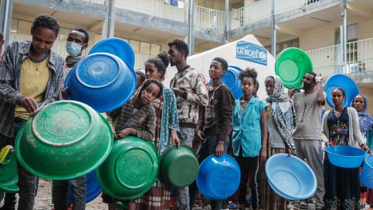 Displaced people in Ethiopia's Tigray region queue up to receive their only meal of the day