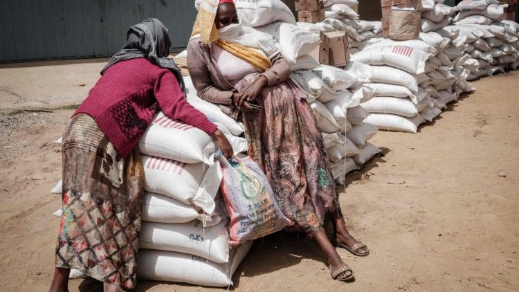 Women displaced from Tigray wait to receive food aid