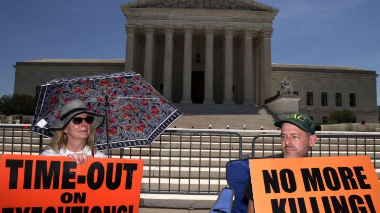 Protesters sit outside the Supreme Court to call for end to the death penalty