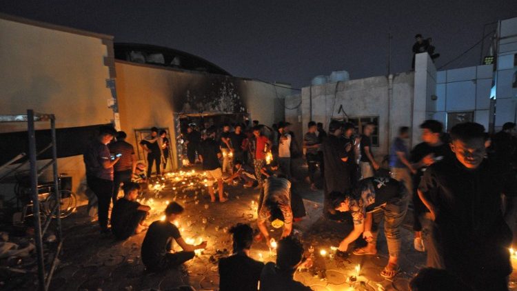 Mourners observing a vigil for the victims of the fire in the Covid-19 ward of a hospital in Nasiriyah, Iraq. 