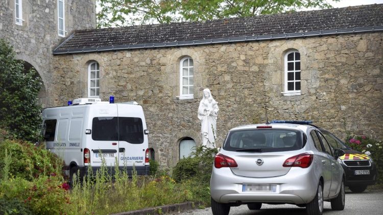 Véhicules de police devant la maison religieuse où a été retrouvé le corps du père Maire
