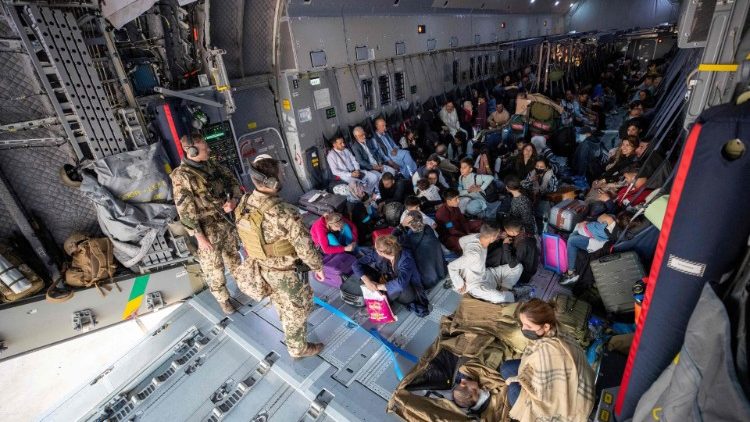 Former Afghan residents sit aboard a German military plane upon arrival in Uzbekistan