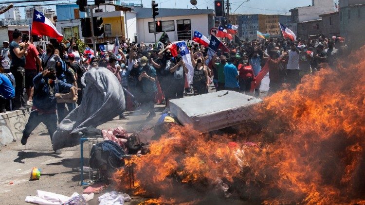 Proteste contro gli immigrati ad Iquique (Cile). I dimostranti bruciano tende e materassi dei migranti (25-09 2021, Afp)