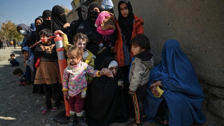 Women with their children in a queue at a WFO food distribution centre near Kabul, Afghanistan.