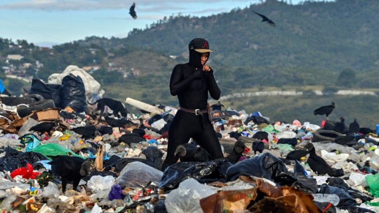 A woman searches through through a municipal rubbish dump in Tegucigalpa, Honduras