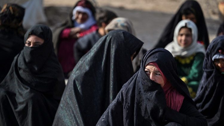 Mothers wait for medical assistance at an international mobile unit in Afghanistan