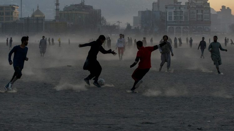 Afghan youth play football at a ground in Chaman-e-Hozori, near Kabul