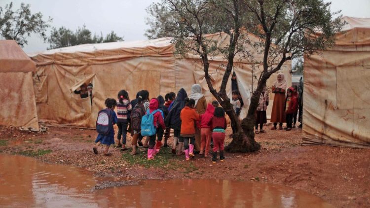 सीरिया के प्रवासी बच्चे क्लास में प्रवेश करने की प्रतिक्षा करते हुए