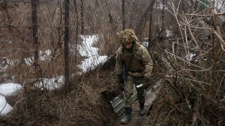 A Ukrainian serviceman walks the front line with Russia-backed separatists in the Donetsk region