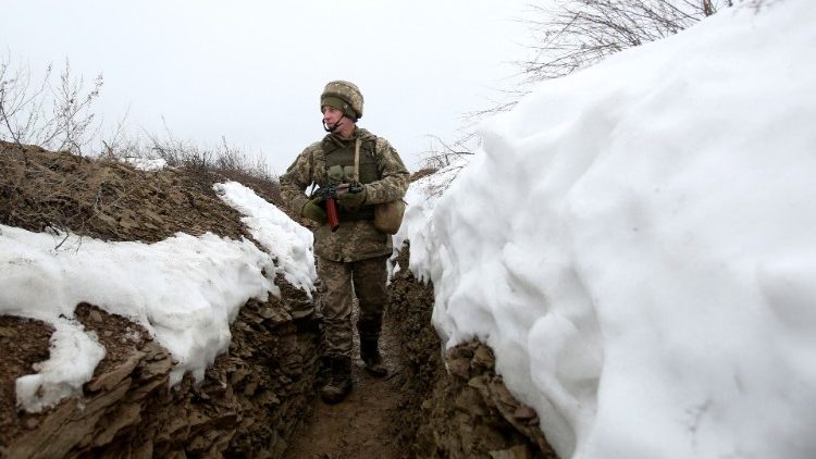 A Ukrainian soldier patrols a trench in eastern Ukraine