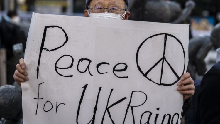 A man holds a placard advocating peace for Ukraine