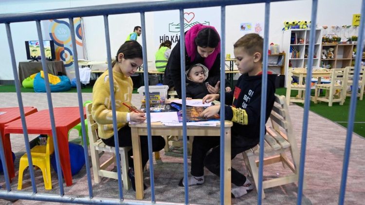 Crianças ucranianas brincam em um playground improvisado no pavilhão esportivo BOK (Centro Olímpico de Budapeste), onde foi instalado um novo abrigo de trânsito para refugiados ucranianos, na capital húngara, Budapeste, em 22 de março de 2022. - Quase 3,5 milhões de ucranianos já fugiram do país após a invasão da Rússia, as Nações Unidas disseram em 21 de março de 2022, elogiando os países vizinhos por mostrarem compaixão esmagadora por sua "situação extrema". Acredita-se que mais de 10 milhões de pessoas – mais de um quarto da população nas regiões sob controle do governo – tenham fugido de suas casas, incluindo os milhões de deslocados internos. (Foto por ATTILA KISBENEDEK / AFP)