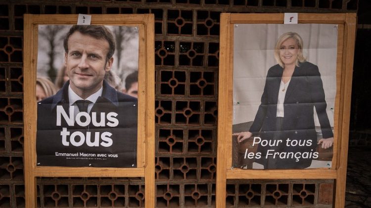 Posters of Macron (L) and Le Pen (R)