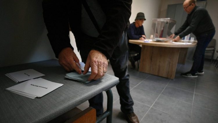 A voter prepares to cast his ballot in Baren, southern France