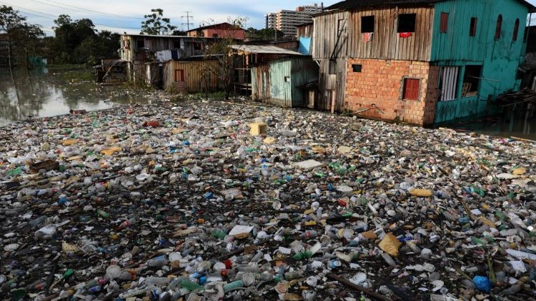 A large quantity of rubbish floats next to houses at Sao Jorge neighbourhood in Manaus, Brazil