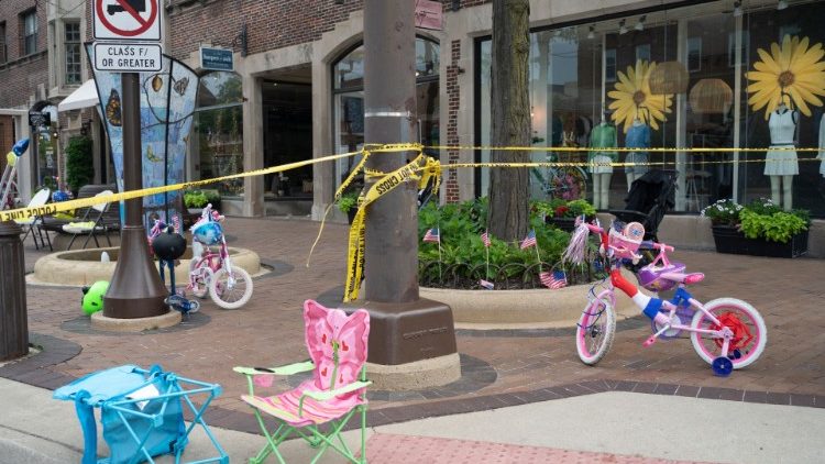 Police crime tape is seen around the area where children's bicycles and baby strollers stand near the scene of the Fourth of July parade shooting in Highland Park, Illinois on July 4, 2022.