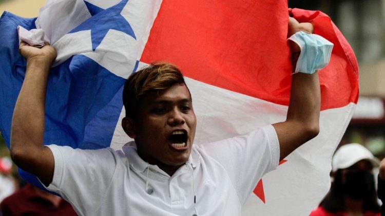 A protester waves a Panamanian flag during a march against the high cost of food and fuel in Panama City, July 2022