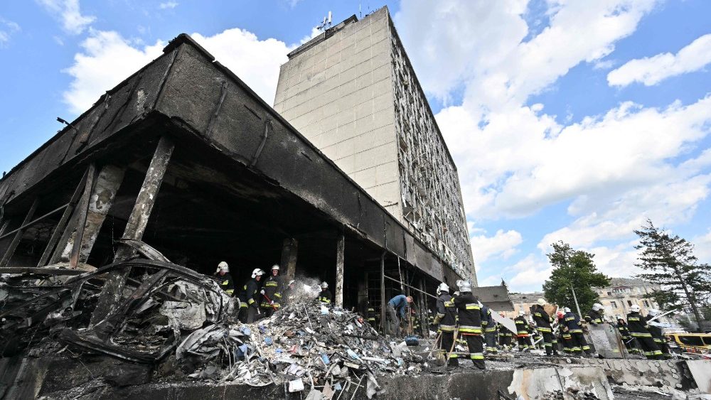 Bombeiros removem escombros de um prdio danificado aps um ataque areo russo na cidade de Vinnytsia, centro-oeste da Ucr?nia em 14 de julho de 2022. - Pelo menos 20 pessoas foram mortas na quinta-feira por ataques russos em uma cidade no centro da Ucr?nia, bombardeios descritos como " um ato abertamente terrorista" pelo presidente ucraniano Volodymyr Zelensky. (Foto de Sergei SUPINSKY/AFP)