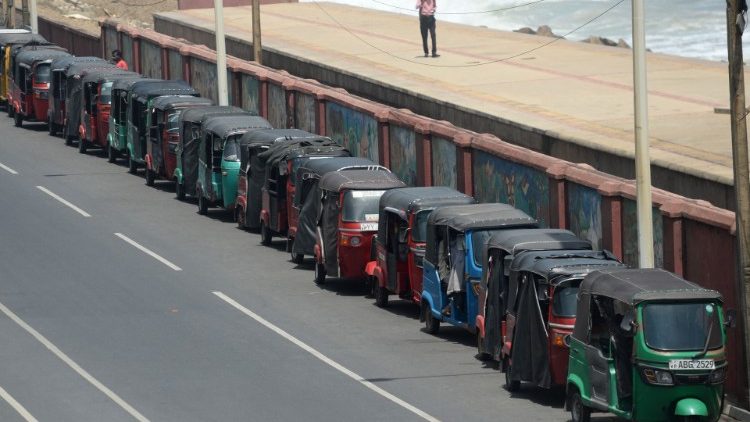 Autorickshaws wait in a long queue for fuel amid the country's economic crisis