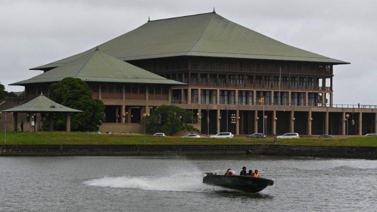 Army personnel patrol on a boat in front of Sri Lankan Parliament in Colombo