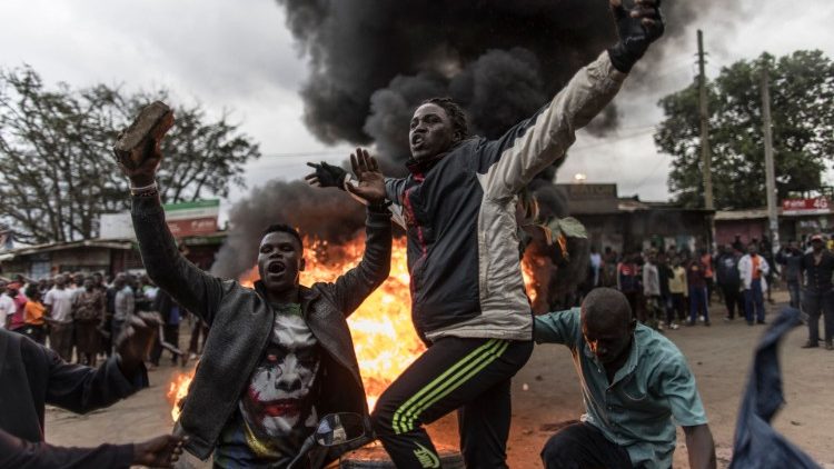 Apoiadores do candidato Raila Ondiga queimam penus em Kibera, Nairóbi. (Photo by Marco Longari/AFP)