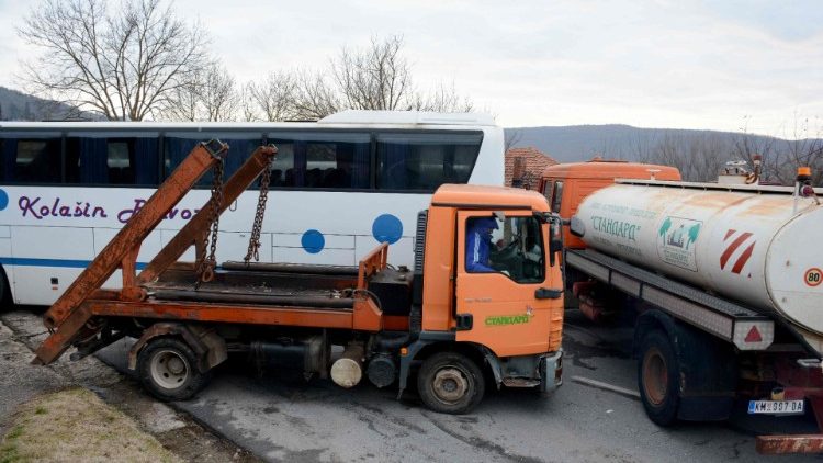 Kosovo Serbs remove a truck from a road barricade in Rudare